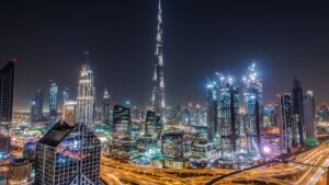 Dubai skyline at night featuring Burj Khalifa and ongoing high-rise developments, illustrating off-plan vs ready property investment opportunities in Dubai in 2026.